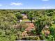 Aerial view of a tree-surrounded home, blending privacy and neighborhood charm at 5806 Fernhill Dr, Orlando, FL 32808
