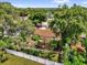 Aerial view of a single-story home surrounded by lush greenery and a white fence, providing a private backyard oasis at 5806 Fernhill Dr, Orlando, FL 32808