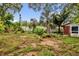 View of the backyard featuring a fence, shed, and some trees at 5806 Fernhill Dr, Orlando, FL 32808