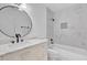 Bathroom featuring white vanity and marble tiled shower at 5806 Fernhill Dr, Orlando, FL 32808