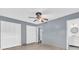 Cozy bedroom with tile floors, ceiling fan, closet, and en suite bathroom at 5806 Fernhill Dr, Orlando, FL 32808