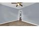 Bedroom features wood floors and ceiling fan with view of the entryway at 5806 Fernhill Dr, Orlando, FL 32808