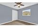 Bedroom with wood floors, ceiling fan, and a bright window near closet at 5806 Fernhill Dr, Orlando, FL 32808