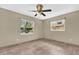 This bedroom features tile flooring, neutral walls, two windows and a ceiling fan at 5806 Fernhill Dr, Orlando, FL 32808