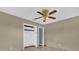 Bedroom with tile floors, ceiling fan and open closet at 5806 Fernhill Dr, Orlando, FL 32808