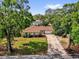 Charming single-story home with a well-manicured lawn and a long driveway at 5806 Fernhill Dr, Orlando, FL 32808