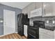 Updated kitchen with black appliances, stylish backsplash, and ample cabinet space at 5806 Fernhill Dr, Orlando, FL 32808