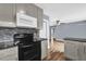 Updated kitchen features modern appliances, sleek countertops, and hardwood floors at 5806 Fernhill Dr, Orlando, FL 32808