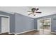 Spacious living room featuring hardwood floors, modern ceiling fan, and sliding glass doors at 5806 Fernhill Dr, Orlando, FL 32808
