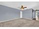 Spacious living room with neutral carpet, ceiling fan, and freshly painted blue walls at 5806 Fernhill Dr, Orlando, FL 32808