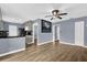 Open-concept living room with hardwood floors and neutral paint, perfect for relaxing and entertaining at 5806 Fernhill Dr, Orlando, FL 32808