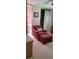 Comfortable bedroom with a cozy armchair, ottoman, and a glimpse into an attached bathroom at 804 Maple Ln, Lady Lake, FL 32159