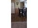 Dining space showcasing dark hardwood floors, a dining table set for four, and kitchen appliances at 804 Maple Ln, Lady Lake, FL 32159