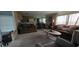 Bright and airy living room with a large seating arrangement, neutral carpet, and access to kitchen at 804 Maple Ln, Lady Lake, FL 32159