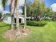 Backyard oasis with palm trees and lush landscaping at 235 Anastasia Dr, Poinciana, FL 34759