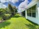 Spacious backyard with lush green grass and mature trees at 235 Anastasia Dr, Poinciana, FL 34759