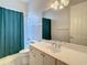 Bathroom with tub shower, vanity, and a large mirror at 235 Anastasia Dr, Poinciana, FL 34759