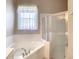 Bathroom featuring a corner bathtub and shower stall at 235 Anastasia Dr, Poinciana, FL 34759