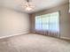 Primary bedroom with large window and ceiling fan at 235 Anastasia Dr, Poinciana, FL 34759