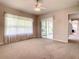 Primary bedroom with sliding glass doors to screened patio at 235 Anastasia Dr, Poinciana, FL 34759