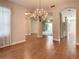 Open dining room with hardwood floors and views to Gathering room at 235 Anastasia Dr, Poinciana, FL 34759