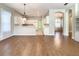 Bright dining room with hardwood floors and view to kitchen at 235 Anastasia Dr, Poinciana, FL 34759