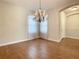 Bright dining room features hardwood floors and a chandelier at 235 Anastasia Dr, Poinciana, FL 34759