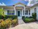 Front entrance with teal door and landscaped walkway at 235 Anastasia Dr, Poinciana, FL 34759