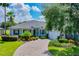 Single story house with lush landscaping and driveway at 235 Anastasia Dr, Poinciana, FL 34759