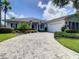 House with a large driveway and neat landscaping at 235 Anastasia Dr, Poinciana, FL 34759