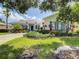 House with lush landscaping and a paved driveway at 235 Anastasia Dr, Poinciana, FL 34759