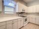 Bright eat-in kitchen with white cabinets and ample counter space at 235 Anastasia Dr, Poinciana, FL 34759