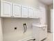 Bright laundry room with upper and lower cabinets at 235 Anastasia Dr, Poinciana, FL 34759