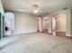 Spacious living room with carpet and views to dining room and entry at 235 Anastasia Dr, Poinciana, FL 34759