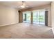 Main bedroom with carpet flooring and sliding doors to lanai at 235 Anastasia Dr, Poinciana, FL 34759