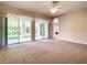 Main bedroom with carpet flooring and sliding doors to lanai at 235 Anastasia Dr, Poinciana, FL 34759