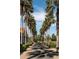 Landscaped palm tree lined driveway leading to community center at 235 Anastasia Dr, Poinciana, FL 34759