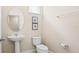 Powder room with pedestal sink and toilet at 5144 Oakbourne Ave, Davenport, FL 33837