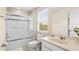 Clean bathroom with a shower/tub combo, vanity, and window at 5144 Oakbourne Ave, Davenport, FL 33837