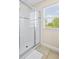 Clean bathroom with a shower and window at 5144 Oakbourne Ave, Davenport, FL 33837