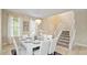 Bright dining room with a white table and chandelier, near a staircase at 5144 Oakbourne Ave, Davenport, FL 33837