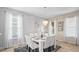 Spacious dining area with a white table and chandelier, offering natural light at 5144 Oakbourne Ave, Davenport, FL 33837