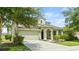 Two-story house with a green exterior, attached garage, and lush landscaping at 5144 Oakbourne Ave, Davenport, FL 33837