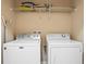 Laundry room features washer, dryer, and overhead shelving at 5144 Oakbourne Ave, Davenport, FL 33837