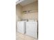 Bright laundry room with washer, dryer, and shelving at 5144 Oakbourne Ave, Davenport, FL 33837