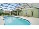 Inviting pool area with screened enclosure, lounge chairs, and spa at 5144 Oakbourne Ave, Davenport, FL 33837