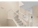 Elegant staircase with white railings at 5144 Oakbourne Ave, Davenport, FL 33837