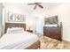 Bedroom with a wicker bed, dresser, and mounted TV at 2968 Salted Rim Rd, Kissimmee, FL 34747