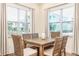 Bright dining area with wooden table and wicker chairs near kitchen at 2968 Salted Rim Rd, Kissimmee, FL 34747