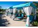 Relaxing poolside cabanas with white curtains and blue accents at 2968 Salted Rim Rd, Kissimmee, FL 34747